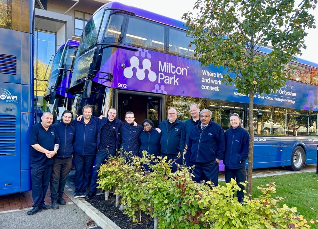 Bus drivers in front of newly-branded buses